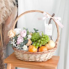 a basket filled with fruit sitting on top of a wooden table