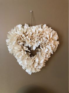 a heart shaped wreath hanging on the wall