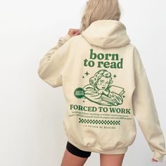 the back of a woman's sweatshirt that reads, born to read forced to work