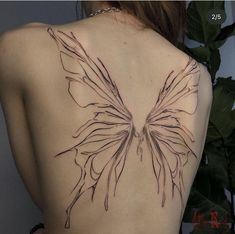 the back of a woman's body with a butterfly tattoo on her left shoulder