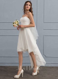 a woman in a white dress holding a bouquet and wearing high heels with her hand on her hip