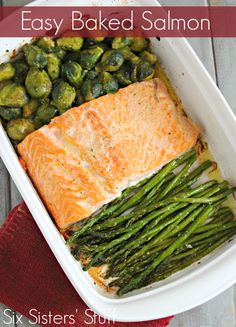 salmon and asparagus in a white casserole dish