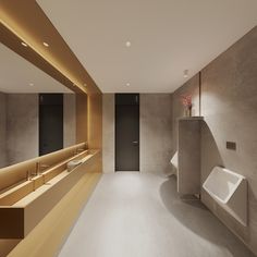 an empty bathroom with sinks and urinals on the walls, along with a long counter