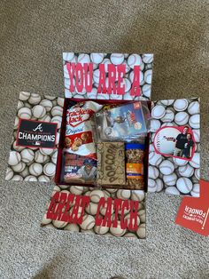 a baseball themed gift box is on the floor