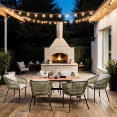 an outdoor fireplace with string lights and chairs around it