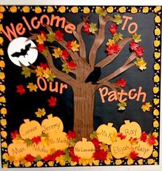 a bulletin board with fall leaves and a tree