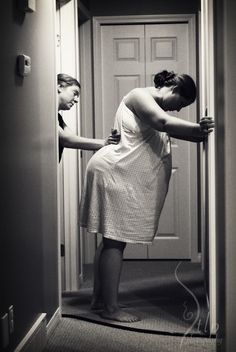 a woman in a white dress is leaning against a door