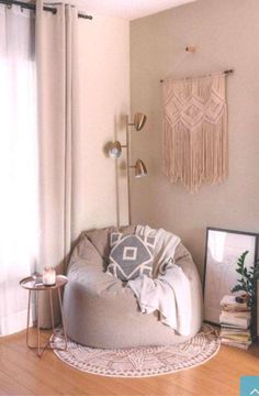 a living room with a large bean bag chair in front of a curtained window