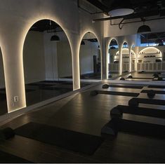 an empty room with black and white tiles on the floor, lit up by lights