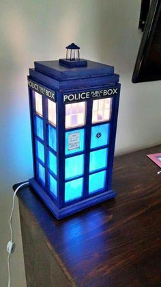 a lamp that is sitting on top of a table in the shape of a police box