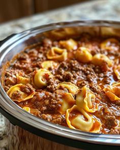 a pot filled with pasta and meat sauce