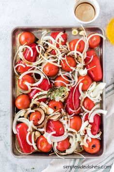 a tray filled with sliced tomatoes and onions