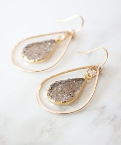 Gold dipped druzy pendants are suspended inside hand forged teardrops with our Della Druzy Teardrop Earrings. Add a touch of sparkle to your earring game with this stunning design that is one of our Top Sellers. Ear wires and frame are made from high quality 14k Gold Fill that will not flake, wear off or discolor over time. CUSTOMIZE by selecting your druzy color preference - color names are noted in photos. Color in earrings pictures and on model is similar to Chocolate. MATERIALS Natural Druzy Hammered Metal Jewelry, Boho Hoop Earrings, Tassel Jewelry, Hammered Gold, Gold Filled Earrings, Earrings Small, Gold Dipped, Jacksonville Fl, Bridesmaid Earrings