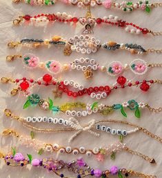 a bunch of bracelets that are sitting on a white tablecloth with words written in them