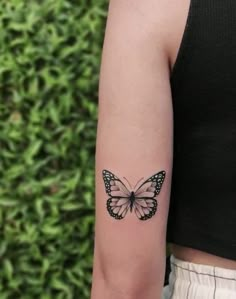 a small butterfly tattoo on the arm