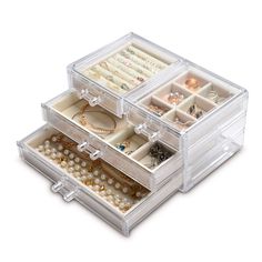 three clear drawers with jewelry in them