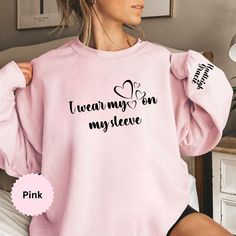 "Introducing our personalized Mom Sweatshirt - the perfect blend of cozy comfort and heartwarming style! Crafted just for you, this sweatshirt proudly declares 'I Wear My Heart on My Sleeve,' adorned with the names of your precious little ones. It's not just a piece of clothing; it's a personalized declaration of your love, making it the ideal Mother's Day gift from your sweet kids. Embrace the warmth and cherish the unique touch of your motherhood journey with our Mama Sweatshirt - because your heart and your sleeve have never looked so good together  HOW TO ORDER  1) Please. Check and Review all Photos. 2) Select Your Shirt Color  3) Select Your Shirt Size.  4) Click ADD TO CART and You can go back to add more product color and text colors or you can complete the checkout process. 5) Ple I Wear My Heart On My Sleeve, I Wear My Heart On My Sleeve Sweater, This Mama Wears Her Heart On Her Sleeve, Personalized Cotton Sweatshirt For Mother's Day, Mother's Day Sweatshirt With Name Print And Crew Neck, Personalized Crew Neck T-shirt For Mother's Day, Personalized Long Sleeve T-shirt For Mother's Day, Motherhood Journey, Cute Shirt Designs