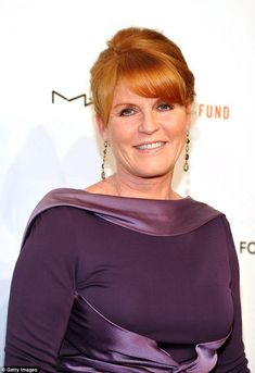 a woman with red hair wearing a purple dress