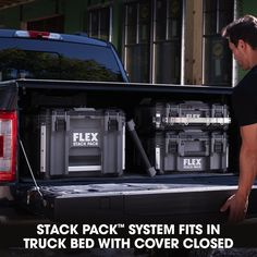 a man loading up the back of a truck with coolers in it's bed