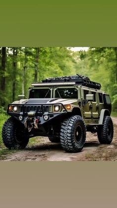 a green hummer truck driving down a dirt road in the middle of a forest