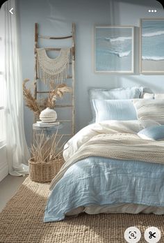 a bedroom with blue and white bedding in the corner, two pictures on the wall