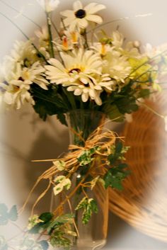 a vase filled with white flowers on top of a table