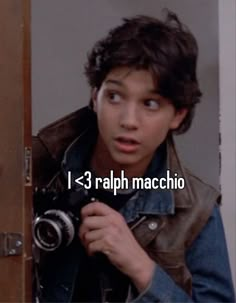 a young man holding a camera up to his face with the caption, i 3 ralph machchio