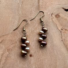 What draws us to a playful strand of pearls is that classic romantic charm. With elegance beyond comparison, this earring set is expertly handcrafted with brown and pale pink potato pearls.  Each bead has a natural shape and beauty that is truly one of a kind. Adding a soft touch of color to your wardrobe has never been easier. We've finished this design with a simple gold wire hook.  Not many pieces of jewelry can effortlessly complement any outfit, but pearls do. From office attire to your favorite date-night dress, our classic earrings partner ever so perfectly with everything in your wardrobe. Brown Pearl Drop Earrings As Gift, Brown Pearl Drop Earrings For Gift, Pink Potato, Strand Of Pearls, Womens Earrings, Brown And Pink, Sea Glass Earrings, Blue Sea Glass, Classic Earrings