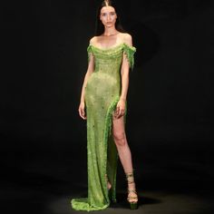 Exquisite evening gown in a captivating green hue, adorned with sparkling crystal embellishments. Features a sophisticated high slit for added allure and elegance. Crafted from high-quality materials for a luxurious and comfortable feel. Designed to enhance the feminine silhouette, beautifully accentuating curves. Inspired by Arabic and Dubai luxury fashion, exuding timeless elegance and sophistication. Ideal attire for women attending weddings, prom, formal parties, or exclusive events. Flatter Green Red Carpet Dresses, Green Evening Dresses, Wedding Gown Simple Elegant, Green Evening Dress, Formal Parties, Dress Drawing, فستان سهرة, Stunning Gowns, Modieuze Outfits