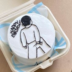 a birthday cake in a box with the words happy birthday written on it and an image of a man's head