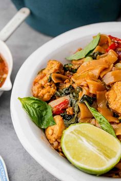 a white bowl filled with chicken and vegetables