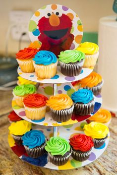 cupcakes are stacked on top of each other and decorated with colorful icing