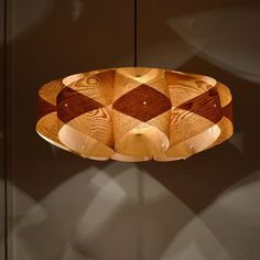 a wooden light fixture hanging from a ceiling