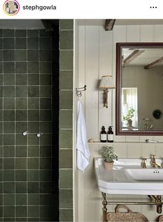 a bathroom with a sink, mirror and towel rack on the wall next to it