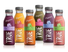 six bottles of organic juice on a white background