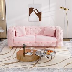 a living room with a pink couch and coffee table