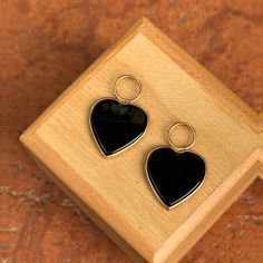 Estate/ Vintage 14KT yellow gold heart-shaped black onyx, bezel-set hooplet earring charms. 1 Pair Large Hearts Not stamped, but tests 14KT Very good estate condition Gold heart measures: 12mm Entire hooplet charm measures 23mm x 15.5 Fits up to 5.5 wide hoops Weighs 3.40 grams for the pair Hoop earrings not included Saint Jewelry, Heart Earring, Earring Charms, Gold Heart, Heart Of Gold, Heart Earrings, Charm Earrings, Bezel Setting, Black Onyx