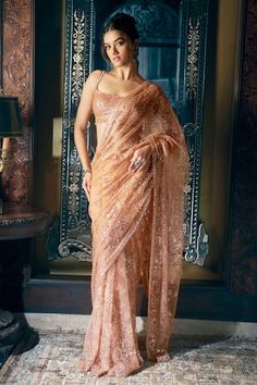 Copper saree features all over tonal sequin and crystal embroidery in a floral pattern. Comes with fully embroidered strappy, padded blouse with tassels at the waist and a petticoat. - Aza Fashions Strappy Blouse, Seema Gujral, Sequin Saree, Crystal Embroidery, Set Saree, Saree Gown, Net Saree, Indian Fashion Designers, Blouse Styles