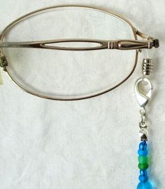 Light Blue Beaded Eyeglass Chain 26.5" in length, made with glass beads, beading cord, metal lobster clasps, and adjustable rubber holders. Lobster clasps make it easy to change the rubber holders, and an extra pair of holders are included with every purchase. This Light Blue Beaded Eyeglass Chain will ship to you in a gift box, securely mailed in a padded envelope. Shipping same or next day, thru USPS Ground Advantage, tracking and insurance included. Once mailed, you can track your package at Adjustable Metal Beaded Necklace With Lobster Clasp, Adjustable Blue Beaded Necklace With Lobster Clasp, Blue Adjustable Glasses Chain For Summer, Bohemian Blue Beaded Glasses Chains, Blue Glass Glasses Chains With Colorful Beads, Adjustable Silver Beads With Lobster Clasp, Elegant Blue Adjustable Glasses Chains, Blue Beaded Glass Glasses Chains, Silver Adjustable Beads With Lobster Clasp