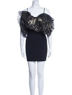 a mannequin wearing a black dress with gold sequins on the shoulders