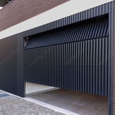 an image of a building that is made out of black slats on the outside