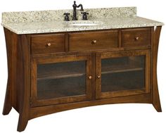 a bathroom vanity with marble top and two drawers on one side, under a faucet