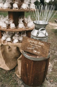 a wooden barrel filled with marshmallows next to a sign that says smores, lean