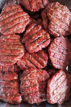 some meat patties are in a metal bowl