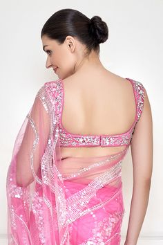 Pink padded blouse with jewel and stone embellished star patterns.
Components: 1
Pattern: Embroidered
Type Of Work: Jewel, stone
Neckline: U-neck
Sleeve Type: Sleeveless
Fabric: Polyester Satin,Net
Color: Pink
Other Details: 
Fitted shilouette
Attached lining
Closure: Back hook
Note: Saree worn by the model is not for sale
Occasion: Party,Cocktail - Aza Fashions Glamorous Designer Blouse With Mirror Work, Glamorous Festive Blouse, Designer Sequined Sleeveless Blouse, Designer Sleeveless Sequin Blouse, Glamorous Sleeveless Blouse For Reception, Embellished Wedding Tops, Hand Embellished Blouse For Parties, Glamorous Embellished Tops For Reception, Festive Embellished Tops For Wedding