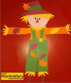 a child's hand made scarecrow with leaves on it