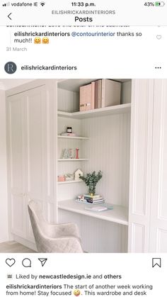 a white chair sitting in front of a book shelf