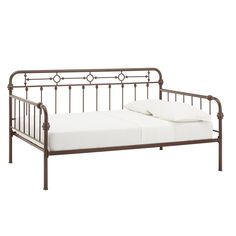 a metal daybed with white sheets and pillows on it's sides, against a white background