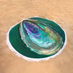 a round object floating on top of a body of water in the middle of sand