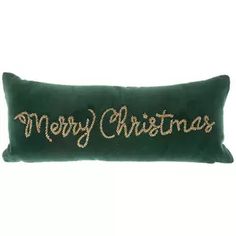 a green christmas pillow with the words merry christmas written in gold glitter on it's side